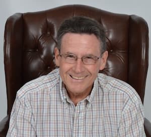 Therapist Rick Carter indoors wearing a striped shirt