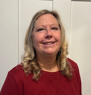 Therapist Schelly Trojan inside wearing a red top